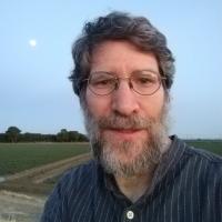 Photo of man standing in front of field