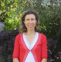 Photo of woman standing in front of vegetation